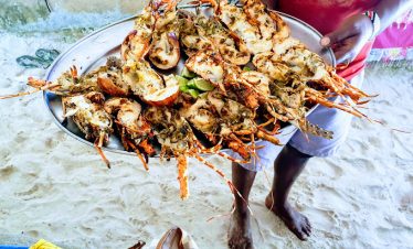 A seller holding crabs
